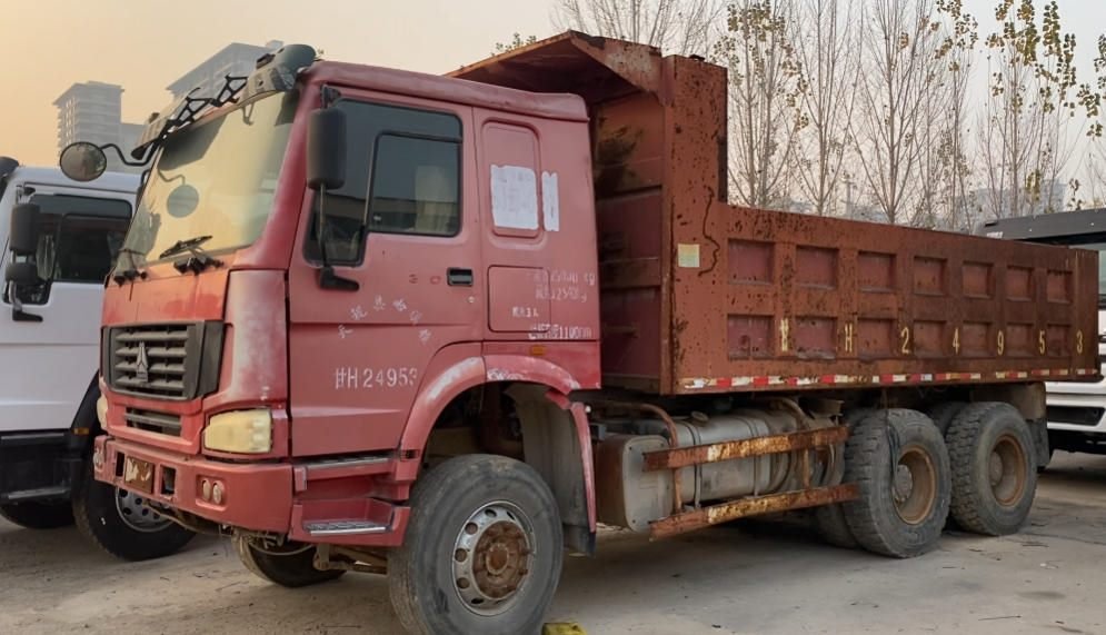 Purchasing specialists inspecting candidate used trucks for remanufacturing value
