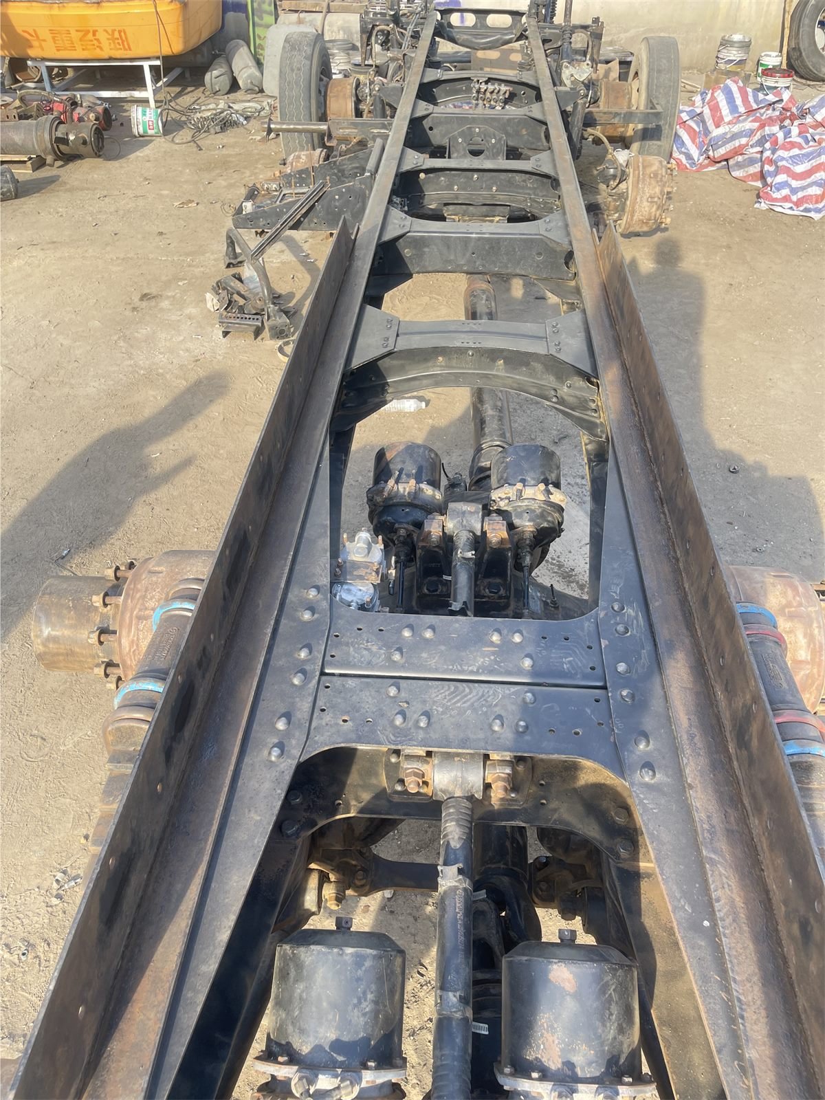 Truck chassis stripped of its drivetrain during integrated dismantling