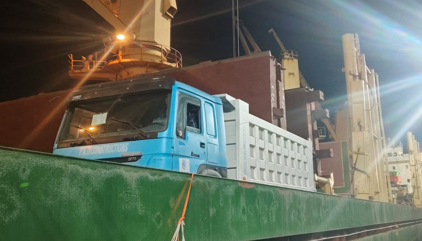 Completed remanufactured trucks secured on board for global delivery